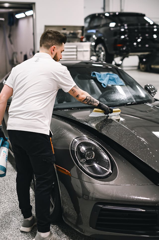 Hood detailing with brush on a sports car